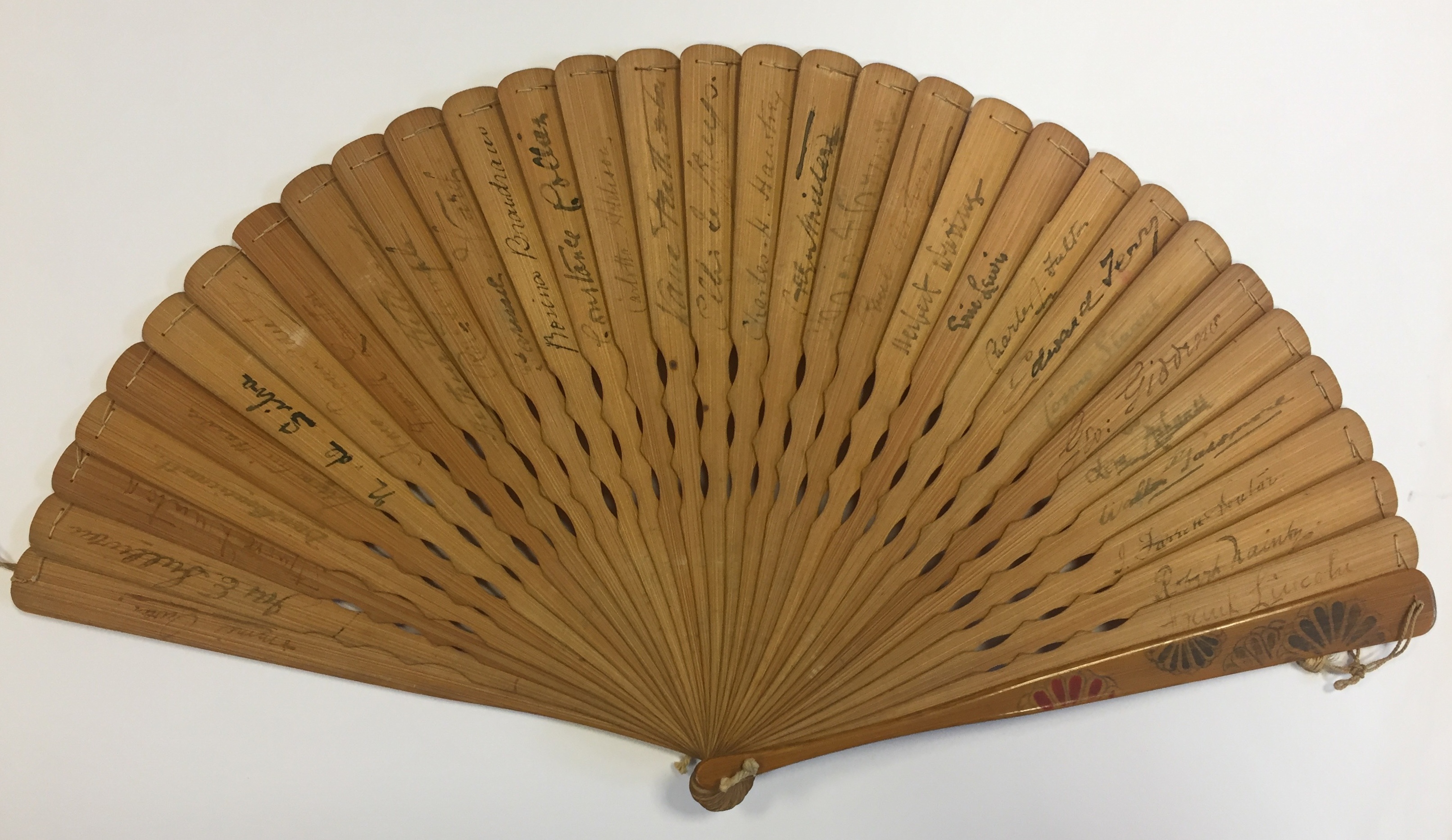 THEATRE: A wooden handheld fan featuring a painted decoration of several Japanese ladies in