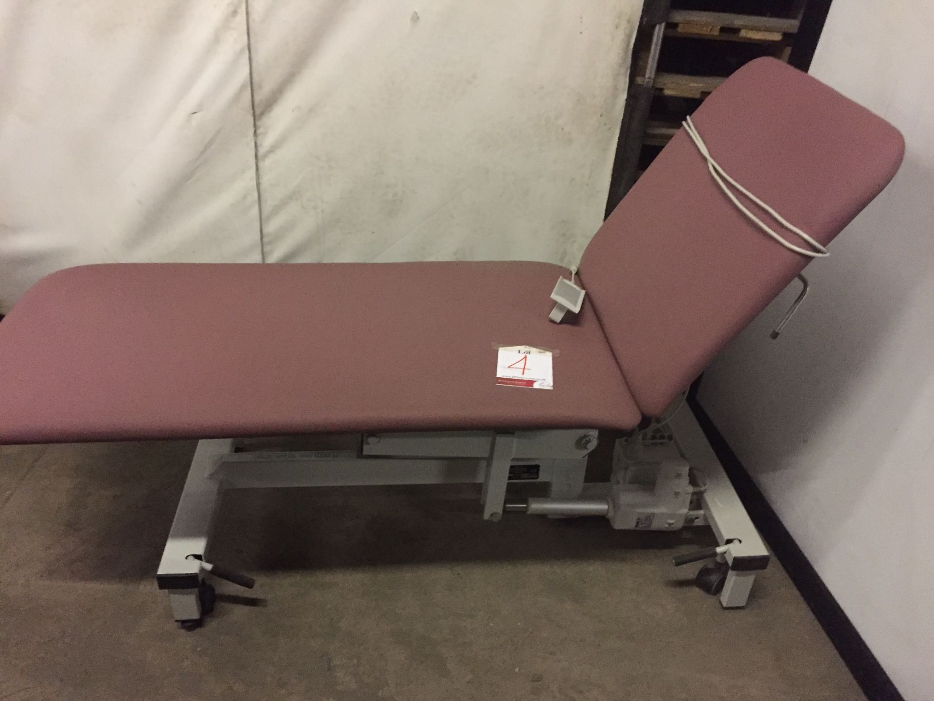 Plinth 2000. Red medical bed, 2 section bed.