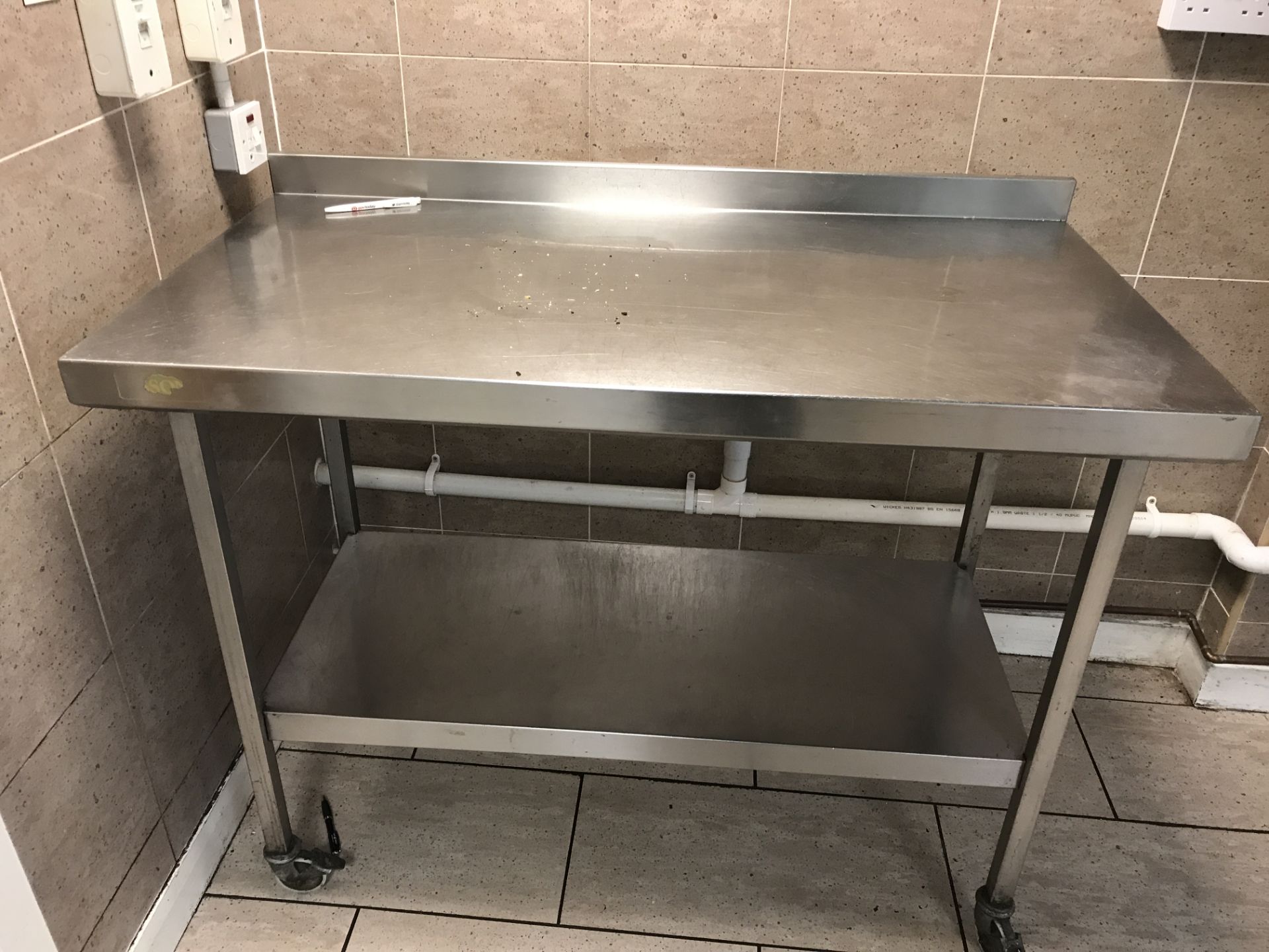 Stainless steel food preparation table 120 x 64 cm with backsplash and undershelf on castors