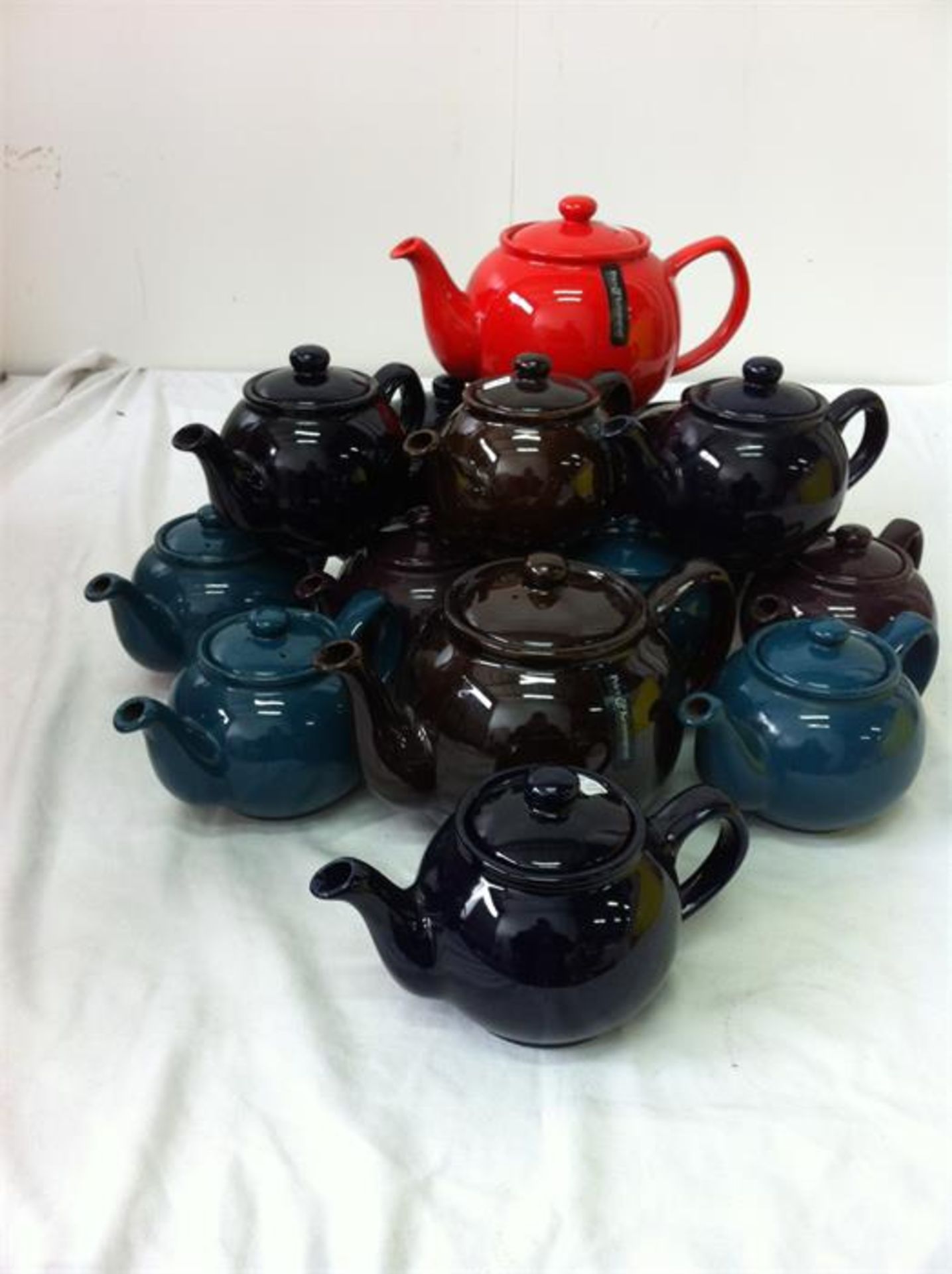 20 small and 6 large ceramic teapots, 3 blue enamel coated coffee pots, 3 white ceramic jugs
