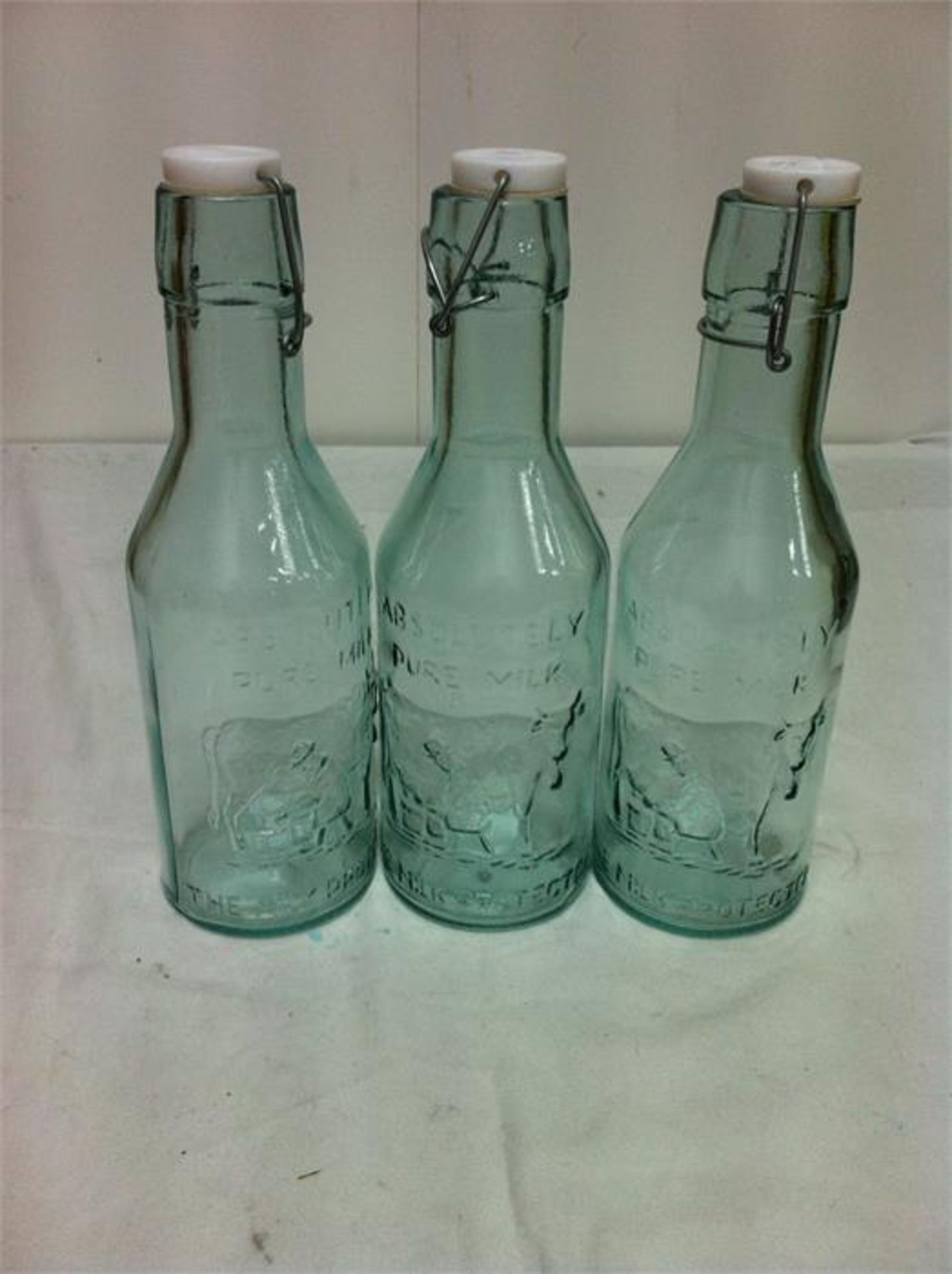 Quantity of 100% recycled glassware; 5 carafes/3 bottles with ceramic tops/4 storage jars/3 candle v - Image 2 of 3