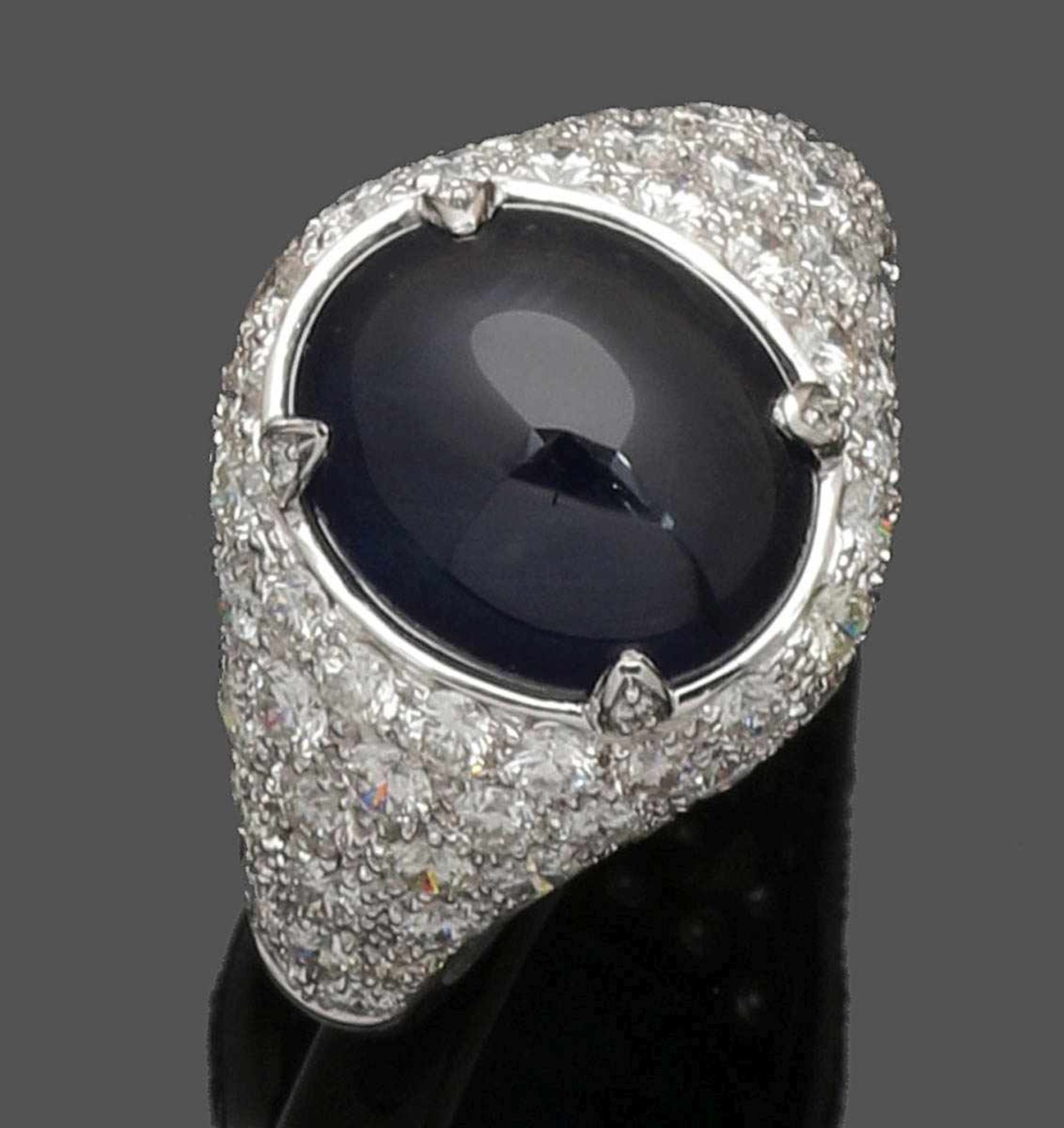 Damensaphirring A Lady's sapphire ring 750er WG, gestemp. 1 ovaler Saphircabochon von 7 ct. Div.