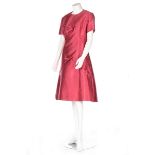Two Norman Hartnell cocktail dresses, mid 1960s, the first of raspberry-red slubbed silk,