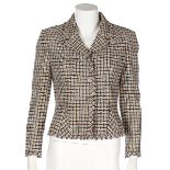 A Chanel tweed jacket, 2003, labelled and size 38, in beige, black, pink and orange check,