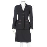 A Chanel black wool and satin suit, 1997, boutique labelled and size 38,