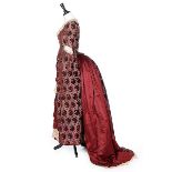 A burgundy voided velvet and satin evening gown, circa 1885,