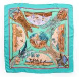 Three Hermès printed silk scarves, with signatures,