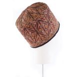 An embroidered hat, Tekke, Turkmen, circa 1900, the cotton ground finely worked with yellow, red,