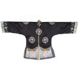 An embroidered winter jacket, Chinese, circa 1910, of navy satin embroidered with crane roundels,