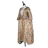 A brocaded satin robe à la polonaise, the silk probably Jean Revel, circa 1735,