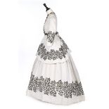 A white matelasse cotton summer gown with black soutache braid, late 1860s, comprising: bodice,