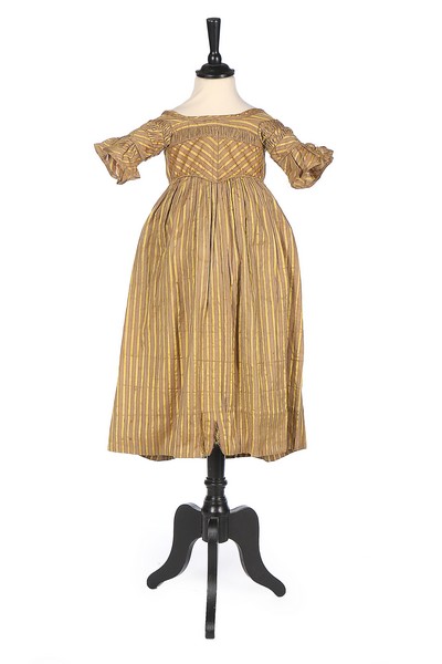 A striped satin girl's dress, late 1830s, with high V-shaped waistline,