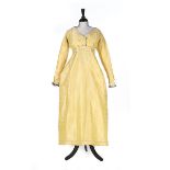 A brocaded yellow changeable silk taffeta gown, circa 1810-15,