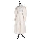 A broderie Anglaise muslin dress, circa 1830, with long, curved gigot sleeves,