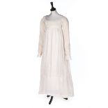 A whitework embroidered muslin dress, circa 1810, empire-line, long sleeves,