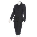 A Chanel black wool suit, probably 1990s, boutique labelled, the jacket with short,
