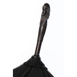 A black silk parasol with carved ebony Sphinx's head, circa 1900, 92cm long,