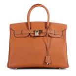 An Hermès tan togo leather Birkin, 2003, blind stamp G, with white top-stitch detailing,