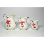 Three Hammersley scalloped graduated jugs, decorated with pink rose and green leaves