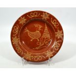 English slipware dish depicting a Rooster and a tree