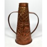 A newlyn style copper twined handled vase, decorated with floral motifs