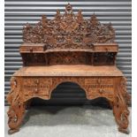 FAR EASTERN HIGHLY CARVED TEAK DESK WITH DEITIES + MYTHICAL ANIMALS