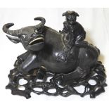 CARVED FRUITWOOD WATER BUFFALO SURMOUNTED BY A CHILD