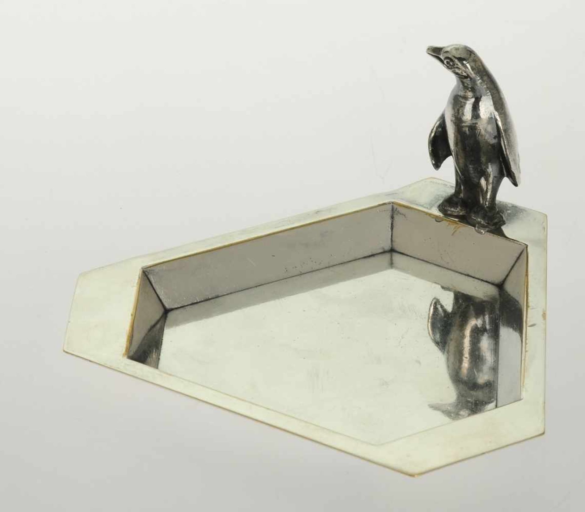 Art-Déco-Schale mit Pinguin Versilbert. Flache dreieckige Form mit abgefasten Ecken. Horizontal