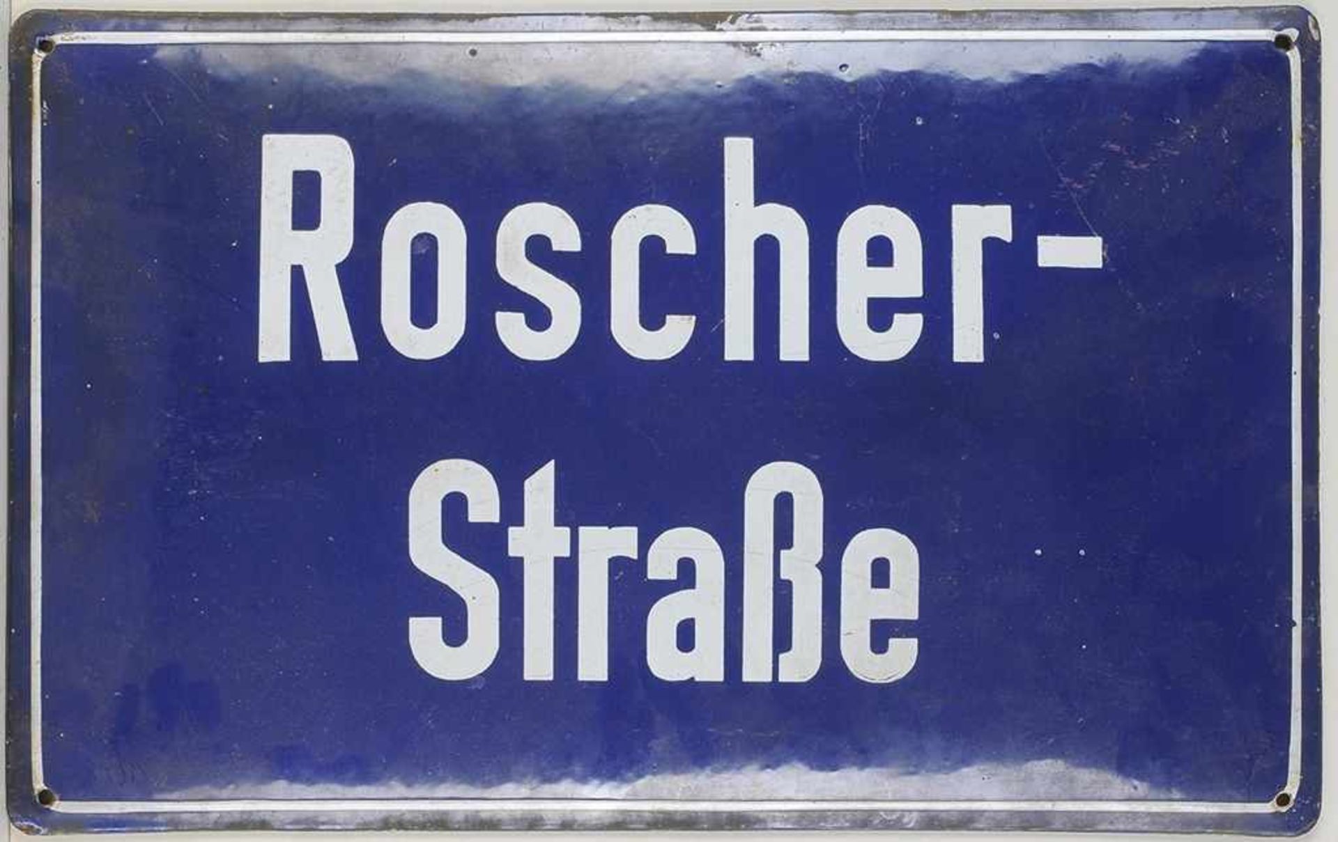 Straßenschild Metall, emailliert. L. gewölbte, querrechteckige Form mit Aufschrift "Roscher-Straße".