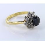 18ct Gold Ring set with central Sapphire surrounded with Diamonds size T weight 6.8 grams