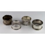 Four ornate silver napkin rings hallmarked as follows - two Chester 1908 and 1912, Birmingham 1897