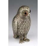 Silver plated pepper pot of an owl with glass eyes, approx 13cm high.
