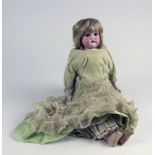 Bisque headed doll in green dress, circa late 19th century, back of neck marked '1896', with open