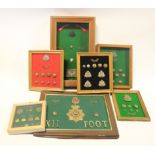 Suffolk Regt - collection of various framed cap badges, collars, titles, buttons, etc. Variety of