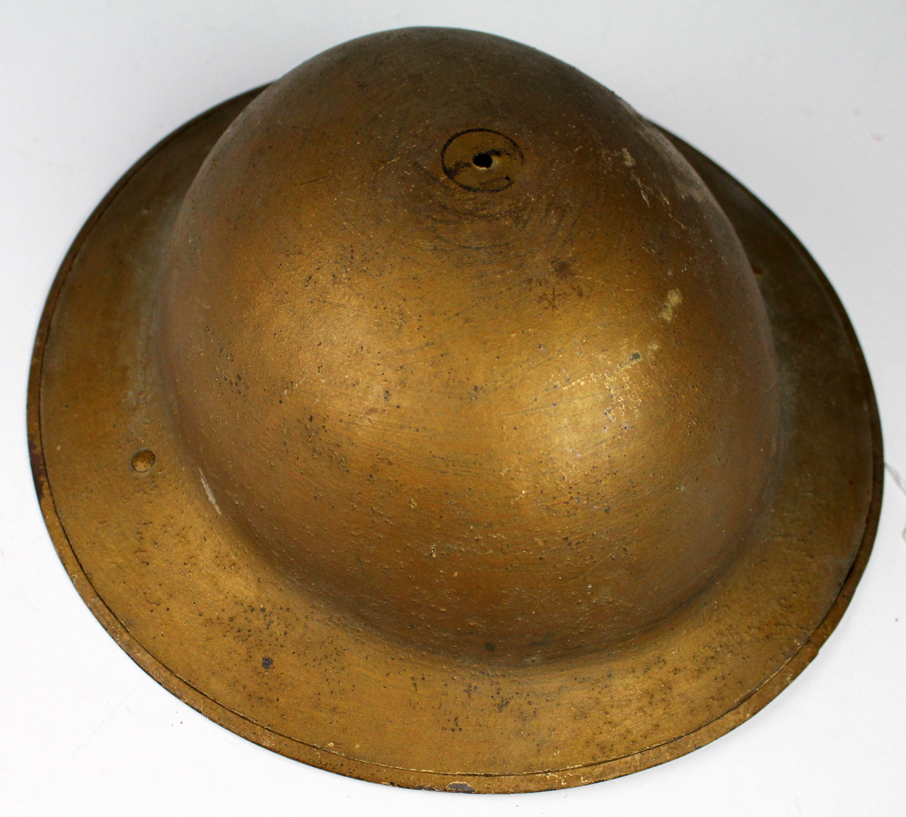 British WW1 Brodie helmet, no liner or chin strap, painted gold. Maker marked