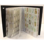 Large album containing 1000+ cards from various issuers in part sets & odds, many cards of