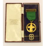 Scouting Medal for Merit in gilt brass, cased. Medal named Miss D E Carrington 26.11.41. With a