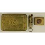 A Princess Mary's Gift tin containing a Royal Artillery trench art matchbox clip & a brass trench