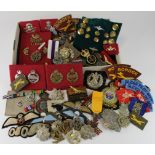 Shoebox of various mixed British military items inc several Cap Badges, Cloth Div badges, buttons,