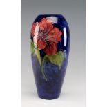 Tall Moorcroft vase decorated with the hibiscus pattern, height 31.5cm approx.