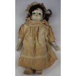 Doll. An early 20th century clockwork musical doll, with bisque head, arms and legs, length 39cm