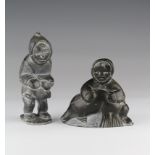 Two Canadian inuit carved stone figures, depicting eskimos, one dated 1986 to base, height 13.5cm