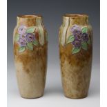 Pair of Royal Doulton stoneware vases, decorated with purple flowers, initialed to base 'MB' with