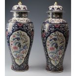 Pair of large urns with lids, by 'Panda', decorated with flowers and birds, height 54cm approx.