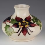 Moorcroft squat vase, decorated with purple and yellow flowers, impressed marks and initialled to