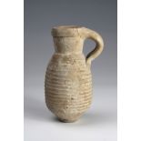 Ancient, complete, pot of grey ware, with circular lip and horizontally lined body, handle has small
