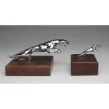 Two leaping Jaguar car mascots, both mounted on wooden plinths, lengths 18cm & 6cm approx.