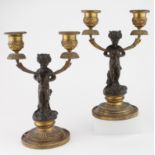 Pair of gilt brass twin candle sticks incorporating bronze Pan figures, 21cm