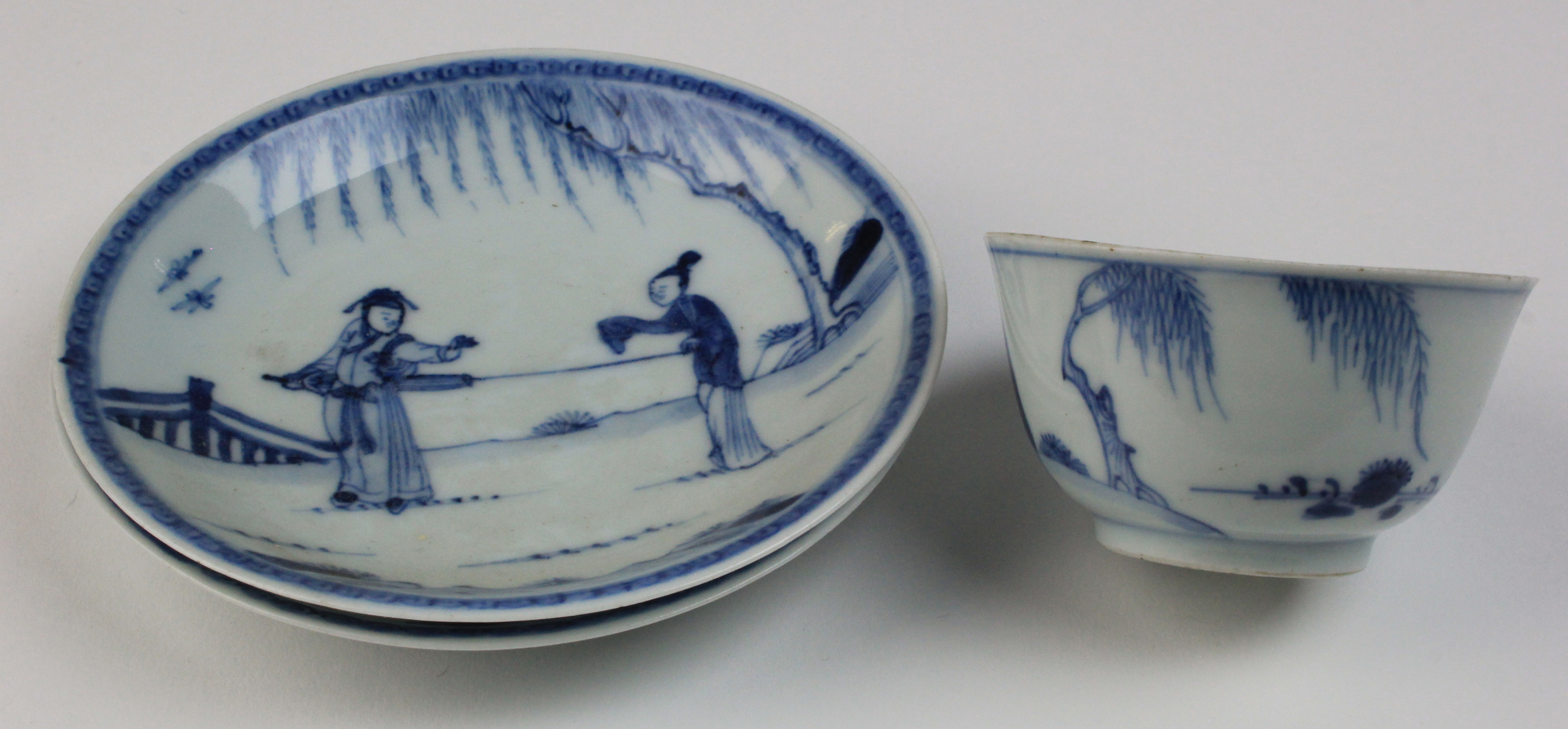 Chinese blue and white, two small dishes and a tea bowl decorated with figures.