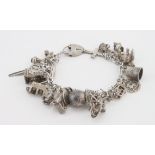 Silver / white metal charm bracelet with a good selection of charms attached, total weight approx